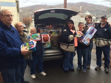 Members of First Baptist Church, Rainelle, W.Va., with toys donated by ABHMS. Second from right is the church’s pastor, David Bush.
