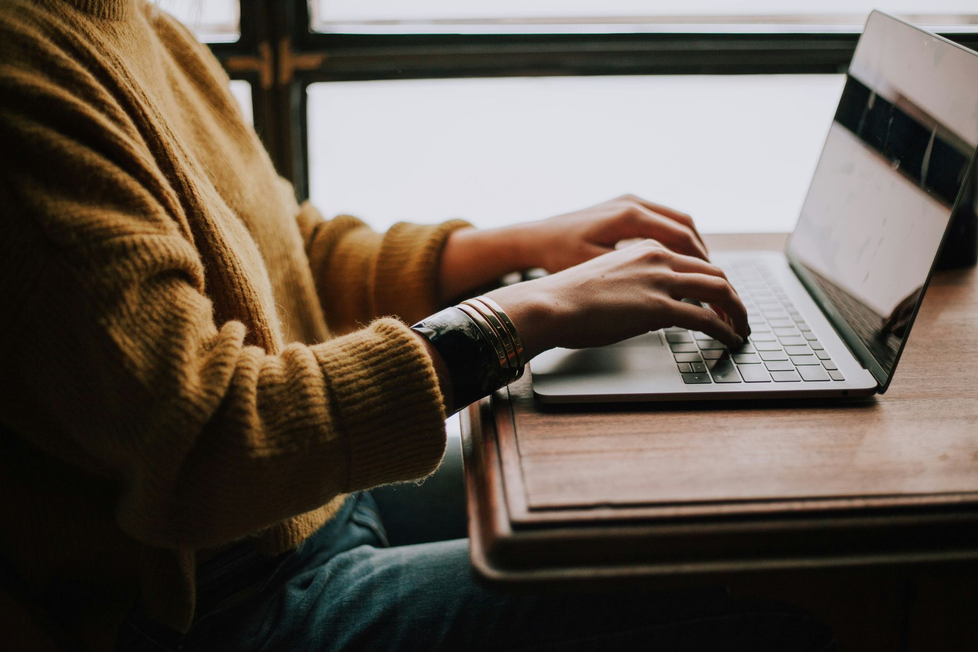 Photo of hands manipulating keyboard on laptop computer.