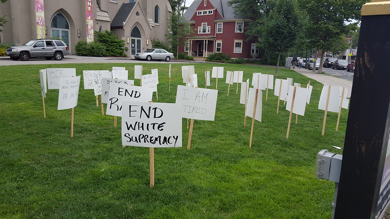 Photo of hand-made yard signs on lawn in front of church